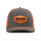 Gray and orange cap with a leather patch on a white background